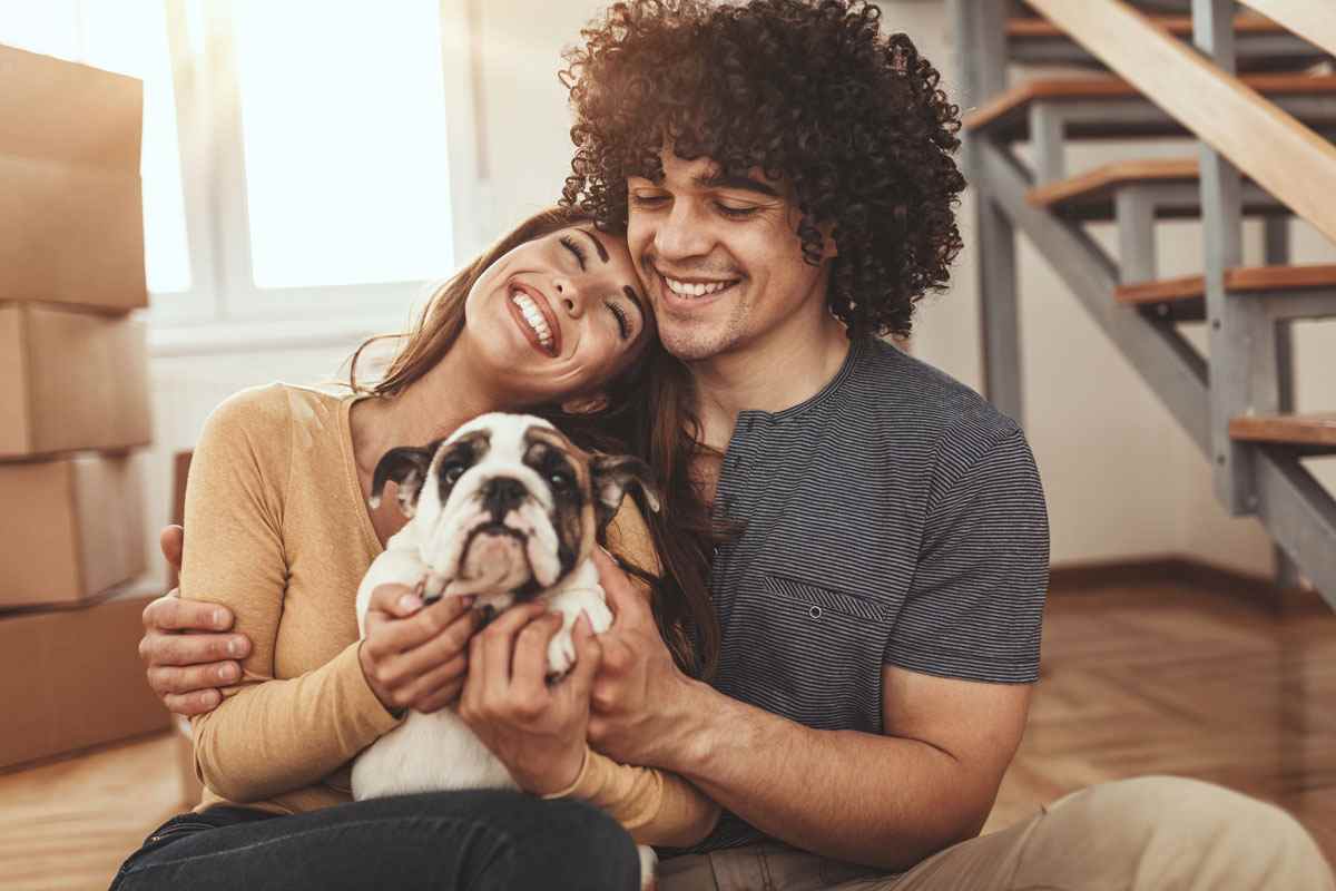 Couple holding their dog - Prudent Pet Customer Referral